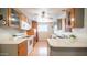 Bright kitchen featuring wood cabinets, countertops, white appliances and a ceiling fan at 2002 S Apache Dr, Apache Junction, AZ 85120