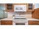 Kitchen featuring white appliances, beige countertops, and wood cabinets at 2002 S Apache Dr, Apache Junction, AZ 85120