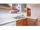 Double sink with white countertops, wood cabinets, with views to another room at 2002 S Apache Dr, Apache Junction, AZ 85120