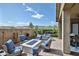 Seating area in a backyard with a fire pit, lounge chairs, and mountain views at 20631 W Minnezona Ave, Buckeye, AZ 85396