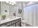 Clean bathroom featuring a vanity with storage, a toilet, and a shower with a curtain at 20631 W Minnezona Ave, Buckeye, AZ 85396