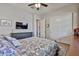 Comfortable bedroom with a queen bed, TV, dresser, closet, and natural light at 20631 W Minnezona Ave, Buckeye, AZ 85396