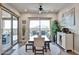 Well-lit dining room with a large table, neutral chairs, and sliding glass doors leading to the patio at 20631 W Minnezona Ave, Buckeye, AZ 85396