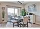 Dining room with large windows, table, chairs, and decorative plants for a bright, inviting space at 20631 W Minnezona Ave, Buckeye, AZ 85396