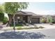 Charming single-story home featuring a well-manicured lawn and inviting front porch at 20631 W Minnezona Ave, Buckeye, AZ 85396