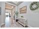 Bright foyer featuring tile flooring, decorative art, and an open view of the dining area at 20631 W Minnezona Ave, Buckeye, AZ 85396
