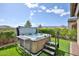 Relaxing backyard with a modern hot tub surrounded by lush greenery, perfect for unwinding and enjoying the outdoors at 20631 W Minnezona Ave, Buckeye, AZ 85396