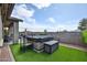 Backyard showcasing a modern hot tub with cover, complemented by artificial turf and a privacy wall at 20631 W Minnezona Ave, Buckeye, AZ 85396