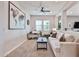 Comfortable living room/office featuring a sofa, desk, large world map and bright natural light at 20631 W Minnezona Ave, Buckeye, AZ 85396