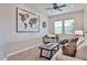 Comfortable living room/office featuring a sofa, desk, large world map and bright natural light at 20631 W Minnezona Ave, Buckeye, AZ 85396