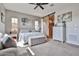 Relaxing main bedroom with soft carpet, ceiling fan, and barn door entrance to bathroom at 20631 W Minnezona Ave, Buckeye, AZ 85396