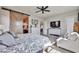 Spacious main bedroom with barn door and a comfortable seating area by the window at 20631 W Minnezona Ave, Buckeye, AZ 85396