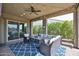 Covered outdoor patio featuring a comfortable seating area, ceiling fan, stylish rug and glass sliding doors at 20631 W Minnezona Ave, Buckeye, AZ 85396