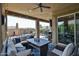 Spacious outdoor patio with stylish seating, string lights, and a ceiling fan for comfortable lounging and entertaining at 20631 W Minnezona Ave, Buckeye, AZ 85396
