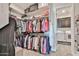 Walk-in closet with organized shelves, hanging racks, and a laundry room access at 20631 W Minnezona Ave, Buckeye, AZ 85396