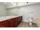Full bathroom with dual sinks, wood cabinetry, and a separate bathtub and shower at 20660 N 40Th St # 1112, Phoenix, AZ 85050
