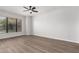 Bedroom featuring wood floors, a ceiling fan, and a large window for natural light at 20660 N 40Th St # 1112, Phoenix, AZ 85050