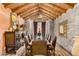 Elegant dining room featuring a long table, stone walls, wood floors, and decorative lighting fixtures at 20660 N 40Th St # 1112, Phoenix, AZ 85050