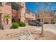 Beautiful condo building with lush landscaping and a neutral colored car parked in front at 20660 N 40Th St # 1112, Phoenix, AZ 85050