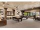 Spacious game room with two pool tables, comfortable seating, and ample lighting for entertaining guests at 20660 N 40Th St # 1112, Phoenix, AZ 85050