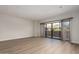 Open-concept living room with wood floors and sliding doors leading to a balcony view at 20660 N 40Th St # 1112, Phoenix, AZ 85050