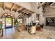 Inviting living room with soaring beamed ceilings, stone fireplace, travertine floors, and ample natural light at 20660 N 40Th St # 1112, Phoenix, AZ 85050