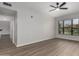Spacious living room featuring laminate flooring and bright windows at 20660 N 40Th St # 1112, Phoenix, AZ 85050