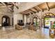 Expansive open area with beautiful tile flooring, exposed ceiling beams, large windows, and comfortable seating at 20660 N 40Th St # 1112, Phoenix, AZ 85050