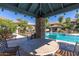 Tranquil pool area with a covered seating area, providing a serene and shaded spot to relax by the water at 20660 N 40Th St # 1112, Phoenix, AZ 85050