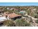 Aerial view of the property with pool, tennis court, lush landscaping, and desert surroundings at 21235 N 80Th Way, Scottsdale, AZ 85255