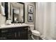 Cozy bathroom offers a modern vanity, toilet, and framed artwork on the wall at 21235 N 80Th Way, Scottsdale, AZ 85255