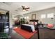 Bedroom features a leather bed frame, mini bar area, and dark hardwood floors at 21235 N 80Th Way, Scottsdale, AZ 85255