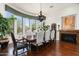 Dining room features a large window view, fireplace, and ornate chandelier at 21235 N 80Th Way, Scottsdale, AZ 85255