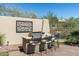 Outdoor kitchen with a built-in grill and bar seating, ideal for entertaining and enjoying the weather at 21235 N 80Th Way, Scottsdale, AZ 85255