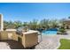 Well-equipped outdoor kitchen and dining area next to a refreshing pool and spa at 21235 N 80Th Way, Scottsdale, AZ 85255