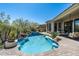 Backyard paradise with a pristine pool, waterfall, and lush landscaping at 21235 N 80Th Way, Scottsdale, AZ 85255