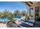 A covered patio overlooks a pristine pool and landscaped backyard at 21235 N 80Th Way, Scottsdale, AZ 85255