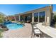 Outdoor bar and seating area overlooking a pristine pool and landscaped backyard at 21235 N 80Th Way, Scottsdale, AZ 85255