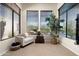 Comfortable sitting area with large windows, cozy furniture, and views of the pool at 21235 N 80Th Way, Scottsdale, AZ 85255