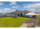 Spacious backyard with green grass, patio area, and a charming picnic table at 22656 E Marsh Rd, Queen Creek, AZ 85142