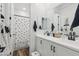 Well-lit bathroom with dual sinks, wood-look flooring, and a patterned shower curtain at 22656 E Marsh Rd, Queen Creek, AZ 85142