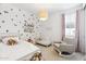 Cozy Bedroom with strawberry wallpaper, crib, and rocker at 22656 E Marsh Rd, Queen Creek, AZ 85142