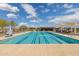 Community pool with lane markers, lounge chairs, and shaded seating area at 22656 E Marsh Rd, Queen Creek, AZ 85142