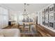 Spacious dining area with stylish light fixture and access to a modern kitchen, creating an inviting and cohesive living space at 22656 E Marsh Rd, Queen Creek, AZ 85142