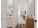 Bright hallway leading to a bathroom and bedroom with natural light, and modern interior design at 22656 E Marsh Rd, Queen Creek, AZ 85142