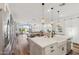 Open floor plan showcasing a modern kitchen with an island, seamlessly connecting to the dining and living spaces at 22656 E Marsh Rd, Queen Creek, AZ 85142