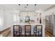 Well-appointed kitchen featuring a large island with bar seating, pendant lights, and stainless steel appliances at 22656 E Marsh Rd, Queen Creek, AZ 85142