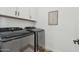 Bright laundry room featuring modern front load washer and dryer, and plenty of storage at 22656 E Marsh Rd, Queen Creek, AZ 85142