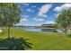 Scenic community pond with lush green lawn and walking path for residents to enjoy outdoor activities at 22656 E Marsh Rd, Queen Creek, AZ 85142