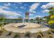 Community splash pad near the lake with seating and shade, great for cooling off on hot days at 22656 E Marsh Rd, Queen Creek, AZ 85142